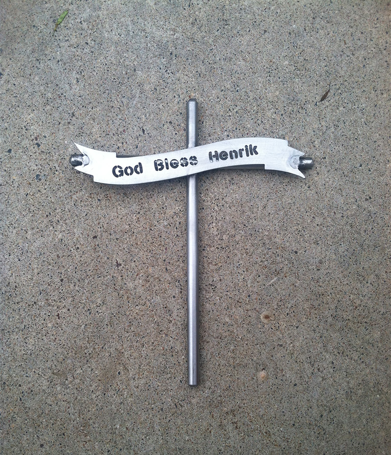 God Bless momento that resembles a cross