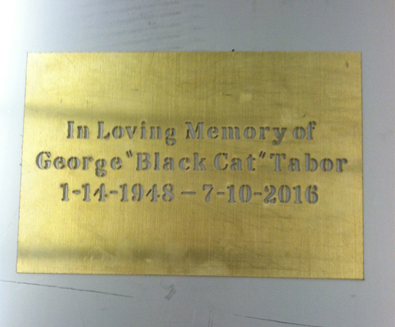 Plaque cut from something gold/bronze looking