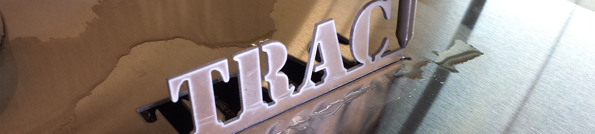 Trac Precision name freshly cut from metal on the water jet.
