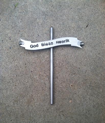 God Bless momento that resembles a cross